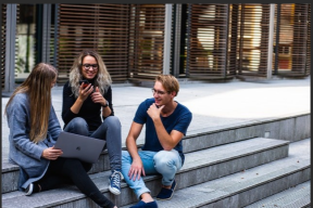 students in a discussion on campus steps