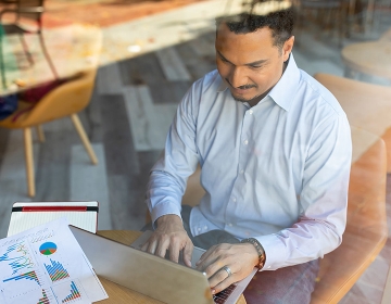 SCU student working on his laptop