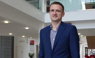 two people holding hands while drinking tea at a table