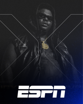 Black and White image of BigXThaPlug in a sleeveless hoodie with a gold medallion necklace