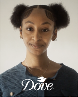 A white Dove logo and a young woman staring forward directly into camera in a blueish grey sweater. 