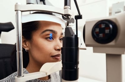 A woman undergoing a professional eye test.