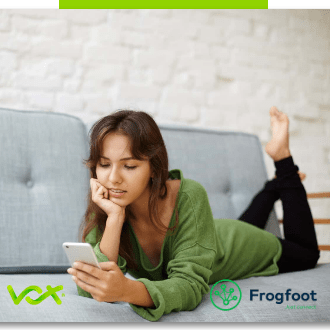 A lady checking her social media with her Vox over Frogfoot fibre connection