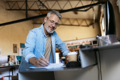 A man who owns a small business on his computer