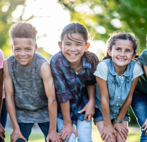 teenage girl smiling with forest background