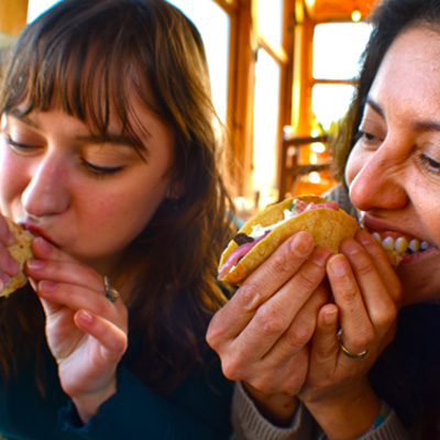 two women eating tacos