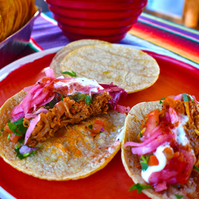 two tacos on a red plate