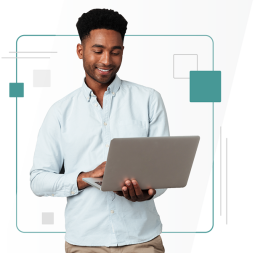 Individual holding a laptop and smiling 