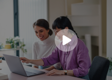 two women looking at a laptop