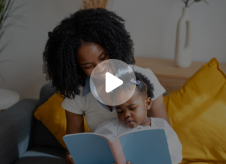 A mom reading to her daughter