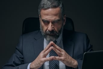 man in business suit with hands together