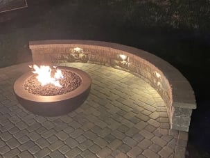 seat wall on paver patio with a fire table