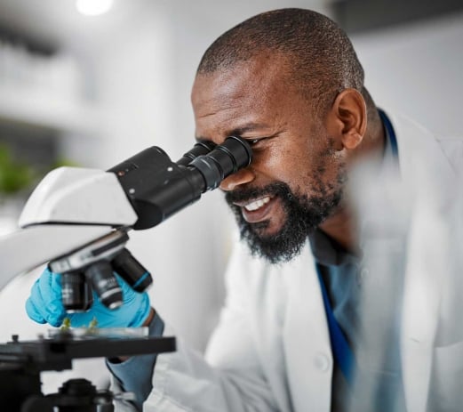 Biologist looking in microscope