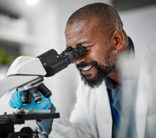 Biologist looking in microscope