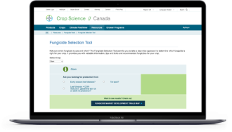 A laptop showing the Bayer website. The Fungicide Selection Tool is visible on the screen.    