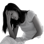 A woman holding her head on a bed in insomnia distress, seeking Bowen therapy relief in one session.  