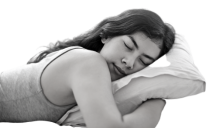A woman sleeping peacefully on her bed, enjoying relief from insomnia with Bowen therapy in one session.  