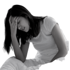  A woman holding her head on a bed in insomnia distress, seeking Bowen therapy relief in one session.  
