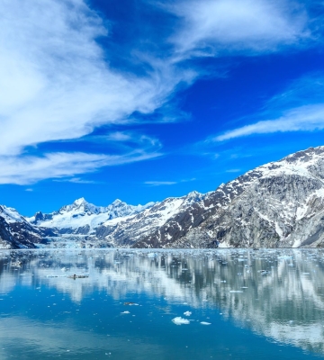Aerial view of Phoenix neighborhoods with downtown skyline and mountains in the background.