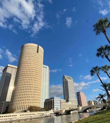 Aerial view of Phoenix neighborhoods with downtown skyline and mountains in the background.
