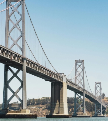 Aerial view of Phoenix neighborhoods with downtown skyline and mountains in the background.