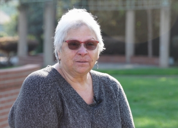 Homeowner seated at a table in a Joe Homebuyer office, giving a testimonial about their selling experience.