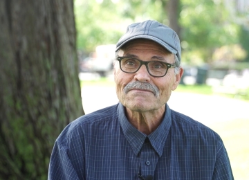 Homeowner sitting in a Joe Homebuyer office, sharing their selling experience.