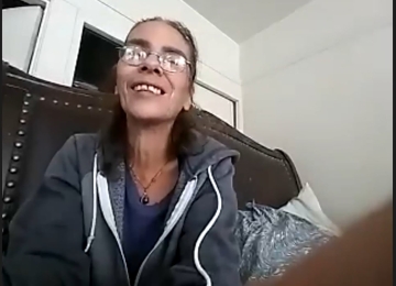 Homeowner seated at a table in a Joe Homebuyer office, giving a testimonial about their selling experience.