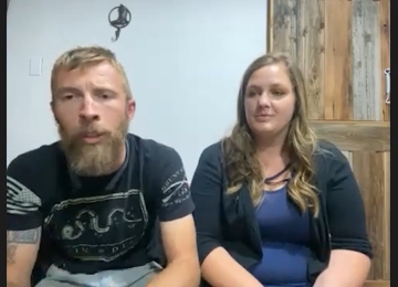 Couple seated in a Joe Homebuyer office sharing their home-selling experience.