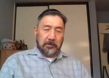 Homeowner sitting in a Joe Homebuyer office, sharing their selling experience.