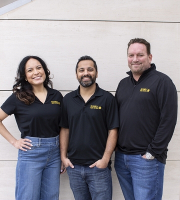 Joe Homebuyer team members standing together in branded shirts, ready to help homeowners sell with confidence.