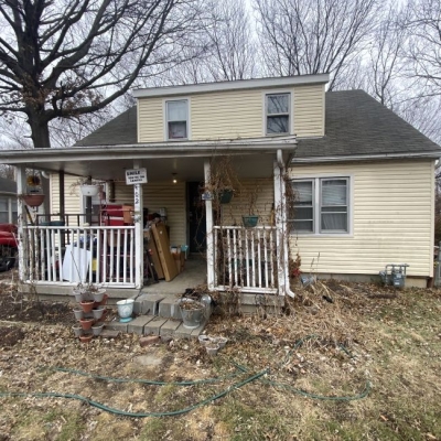 Aerial view of Phoenix neighborhoods with downtown skyline and mountains in the background.