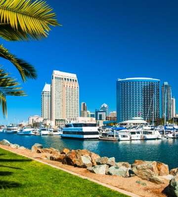 Aerial view of Phoenix neighborhoods with downtown skyline and mountains in the background.