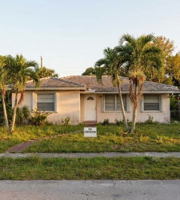 Aerial view of Phoenix neighborhoods with downtown skyline and mountains in the background.