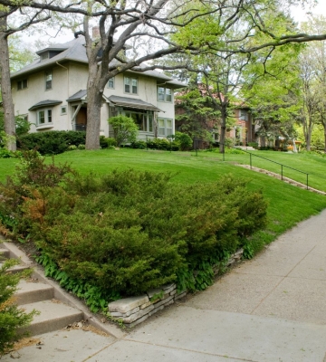 Aerial view of Phoenix neighborhoods with downtown skyline and mountains in the background.
