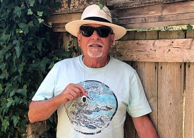 Older man holding alarm pendant