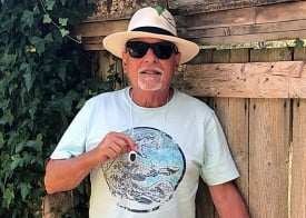 Older man holding alarm pendant