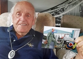 Older man holding alarm pendant