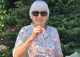 Older man holding alarm pendant