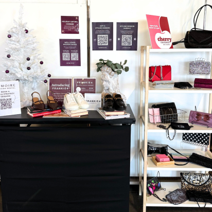 Picture of the gifting corner. It shows handbags, shoes, and QR codes to online products.