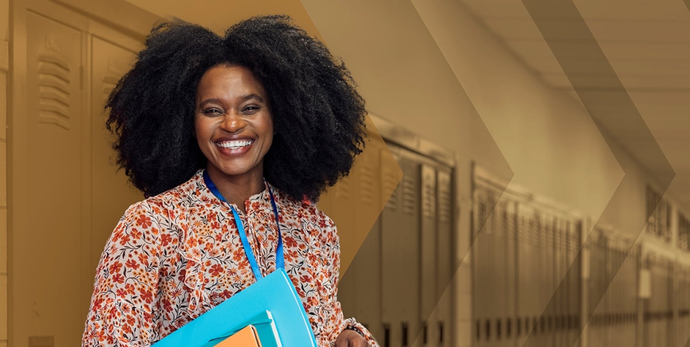 Woman in floral shirt with blue lanyard smiling at viewer