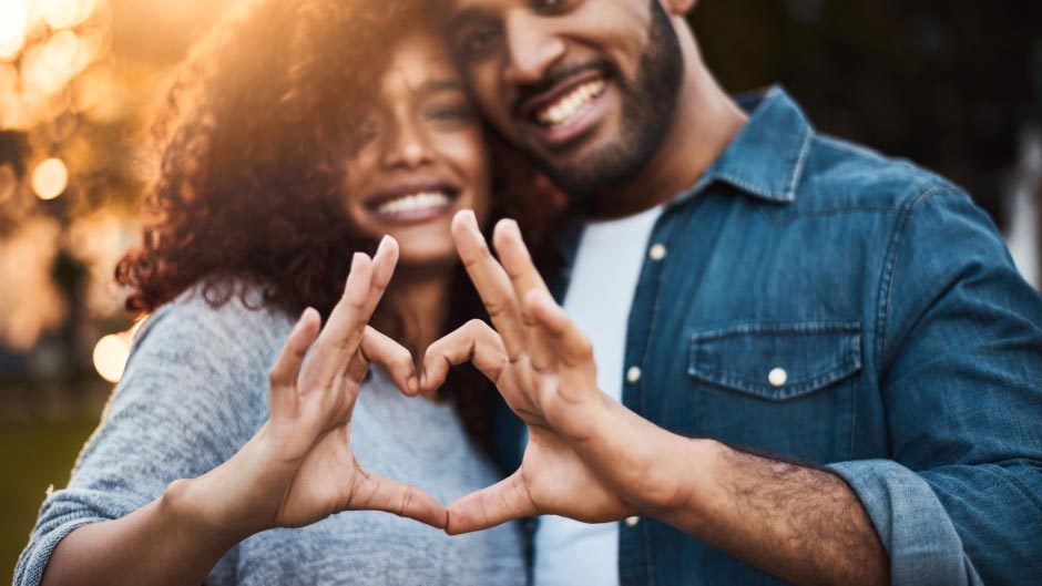 Man and Woman Creating a Heart with their Hands