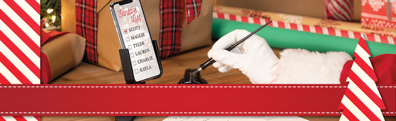 Santa with a quill pen writing down names using a WeatherTech DeskFone.