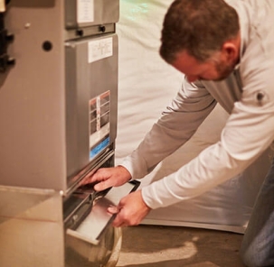 Technician looking at furnace filter
