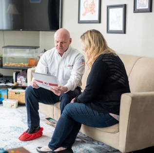 Technician going over paperwork with homeowner