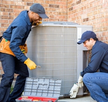 Two technicians working on AC