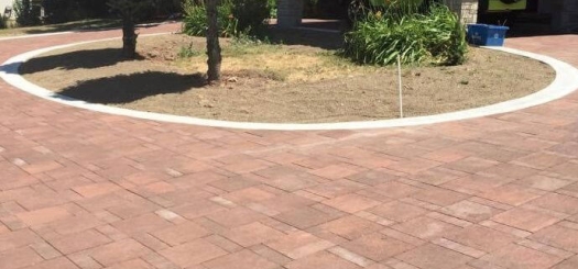 A circular garden with a yellow jeep parked in a garage.