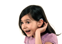 young girl with hearing aid image