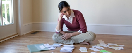 woman going over bills on the floor image