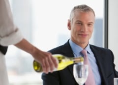 waitress pouring man wine